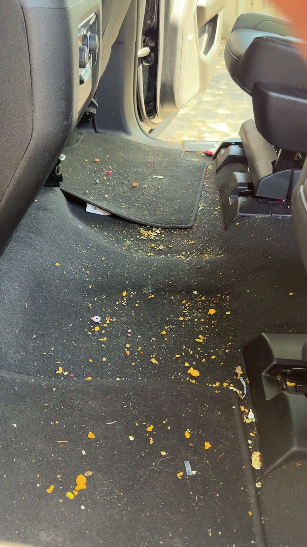 Rear seat floor crumb and debris removal — before